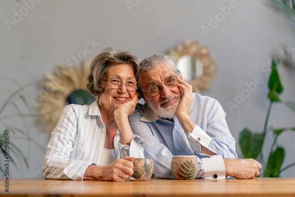 Fototapeta elderly people sitting at the table drinking tea together happy old age memories of an elderly couple pleasant leisure time in old age warm feelings support in old age