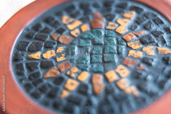 Fototapeta A detailed shot of a natural stone mosaic with earthy tones, showcasing intricate craftsmanship and the beauty of combining terracotta with mosaic elements