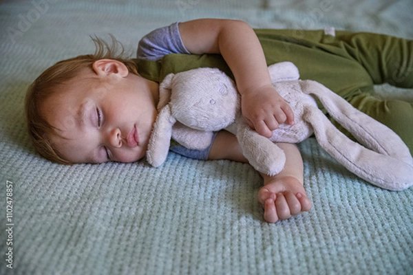 Fototapeta Sleeping Toddler Cuddling a Soft Plush Toy