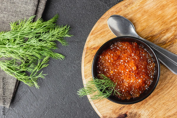 Obraz Red salmon caviar with fresh dill in a bowl