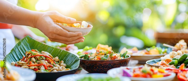 Obraz Travel concept of street foods and local cuisine. A person serving colorful dishes at a vibrant outdoor setting, showcasing a variety of fresh and healthy foods.