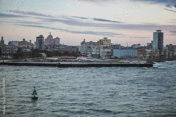 Fototapeta A beautiful evening view of Havana, Cubas skyline along the waterfront with gentle waves