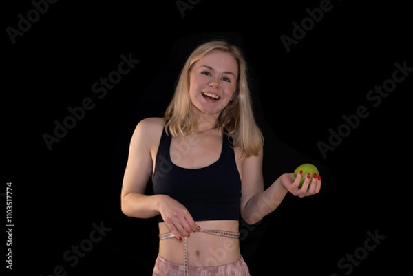 Obraz Smiling Girl Measuring Waist with Tape and Holding Green Apple, Fitness and Healthy Lifestyle Concept