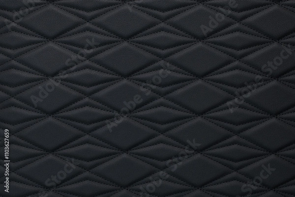 Fototapeta A close-up of black leather upholstery with diamond-shaped stitching.