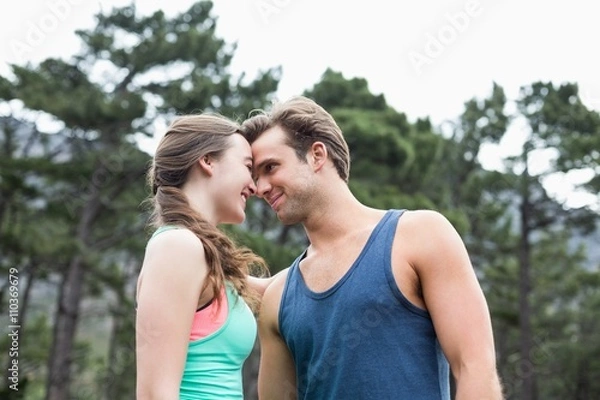 Obraz Low angle view of young couple couple at forest