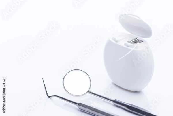 Obraz Dental floss with basic dental tools on a white table