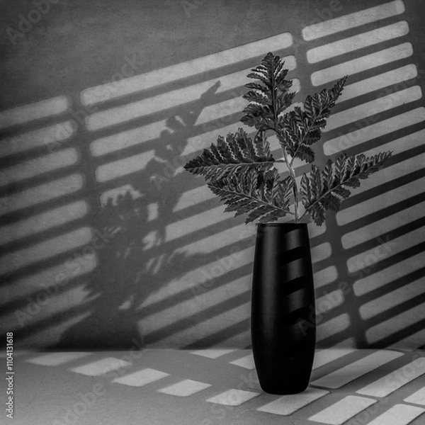 Fototapeta Fine Art Still Life Black and White image of a Fern in a Small Black with Lighting from a blind vase in Square Format
