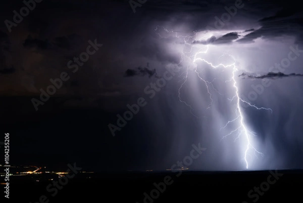Fototapeta Thunderstorm lightning strike with illuminated rain