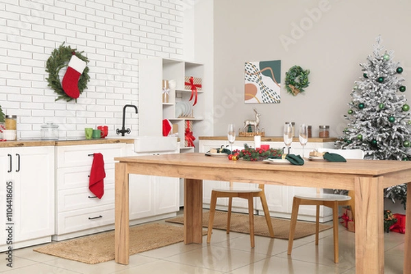 Fototapeta Interior of kitchen with counters, Christmas tree and dining table
