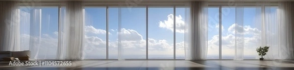 Fototapeta A spacious room with large windows showcasing a bright sky and clouds.