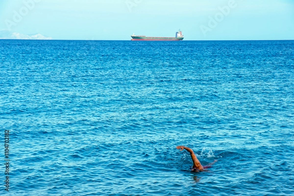 Obraz Further and further away. Swimming in the sea.