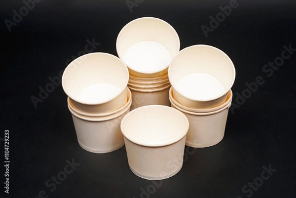 Fototapeta Disposable kraft paper bowls, isolated on black background. High resolution photo.