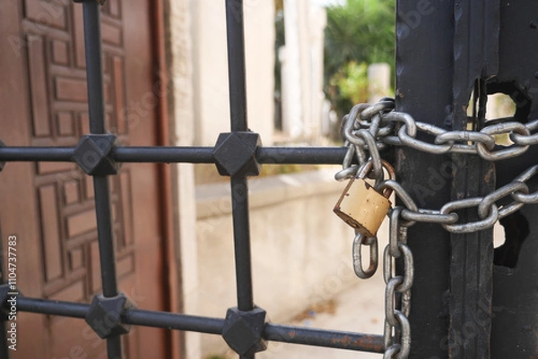 Fototapeta A Secured Gate featuring a Padlock and Chain for enhanced protection and safety measures