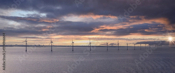 Obraz Renewable energy wind power plant and wind turbines along sea shoreline.