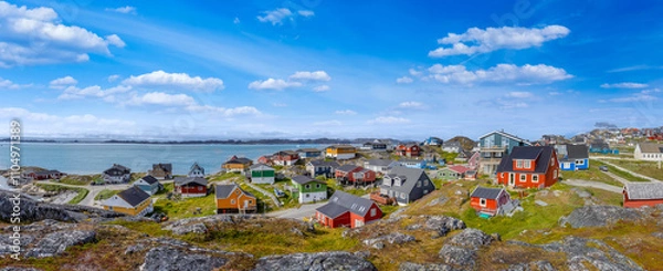 Obraz Typical architecture of Greenland capital Nuuk with colored houses located near fjords and icebergs.