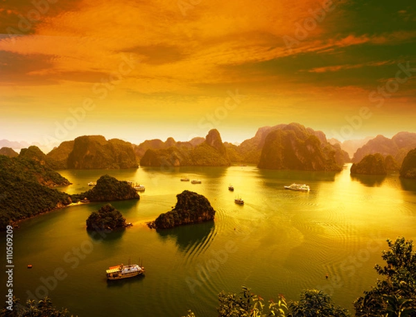 Fototapeta HALONG bay in sunset in vietnam. UNESCO World Heritage Site. This view from TiTop island and its most popular view for travel in Halong bay.
