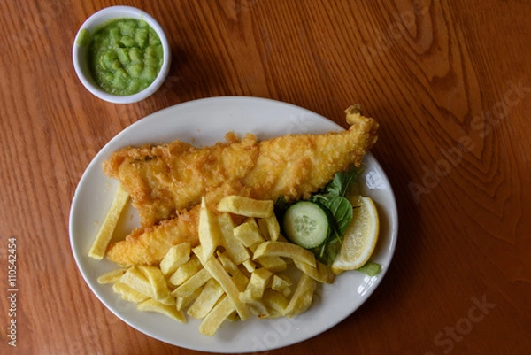 Obraz Fish and Chips served on plate with mushy peas