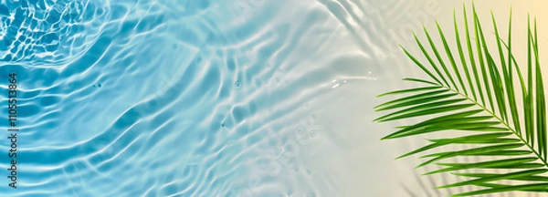 Obraz abstract sand beach with blue water wave and green palm leaf from above, beach vacation background banner concept with sunlight reflections and copy space for beauty spa, vacation and travel