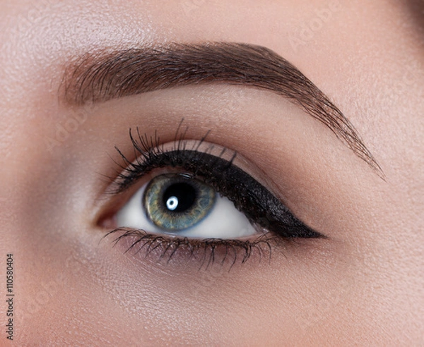 Obraz Female eye close-up. Macro. Perfect makeup and eyebrows. Beautiful gray eyes