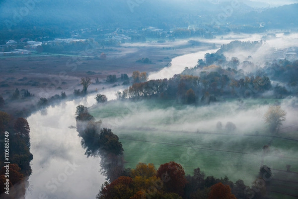 Fototapeta autumnal foggy morning sunrises over the Adda river, Lecco, Italy	
