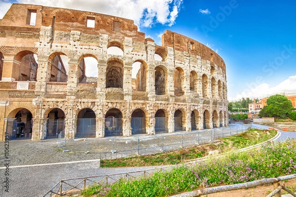 Fototapeta Side view of the Colosseo, Colosseum, Flavian Amphitheatre, the largest amphitheater in the world and one of the symbols of Italy. Symbol of Rome, located in historical center, Unesco Heritage Site.