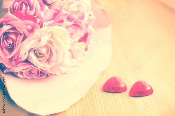 Obraz Bouquet of pink and white rose and two red hearts on a wooden background