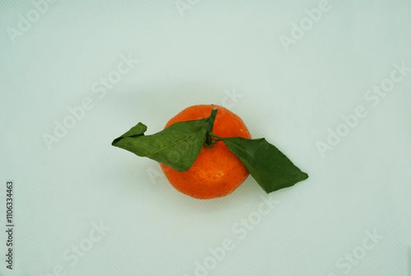 Fototapeta Fresh tangerines with leaves on a colored background, fruits, vitamins.