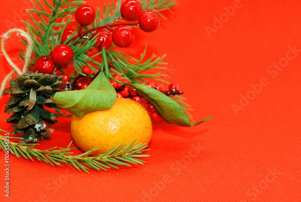 Fototapeta A spruce branch with a pine cone and a tangerine with leaves on a beautiful background, holiday, Christmas.