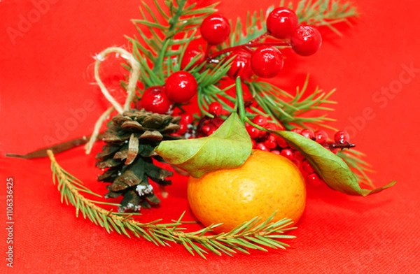 Fototapeta A spruce branch with a pine cone and a tangerine with leaves on a beautiful background, holiday, Christmas.
