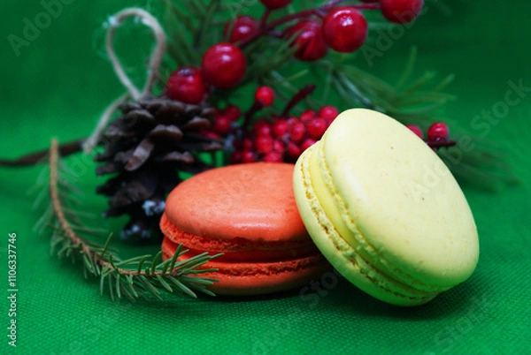 Fototapeta A spruce branch with a pine cone and multi-colored macaroons on a beautiful background, holiday, Christmas.