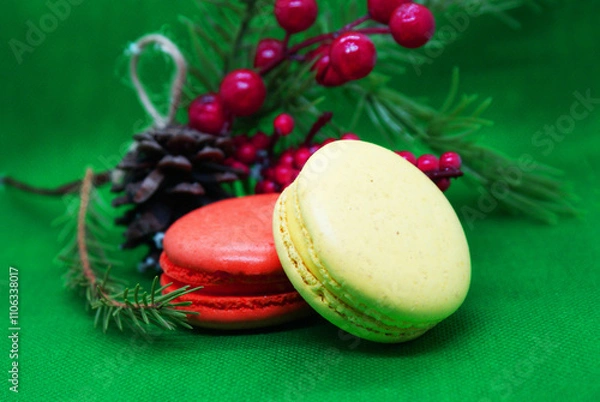 Fototapeta A spruce branch with a pine cone and multi-colored macaroons on a beautiful background, holiday, Christmas.