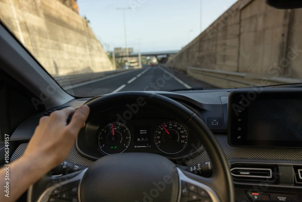 Obraz Driver view to the speedometer, with hand on the steering wheel. Blurred road. Madeira island, Portugal.
