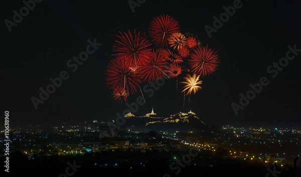 Fototapeta Big colorful fireworks over the palace on the mountain top in Thailand