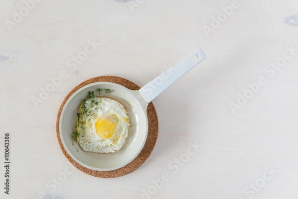 Obraz Fried eggs at white background
