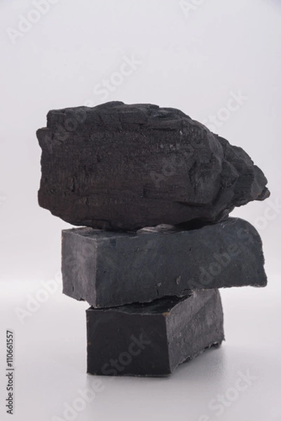 Fototapeta carbon soap  and a pile of coal on white background