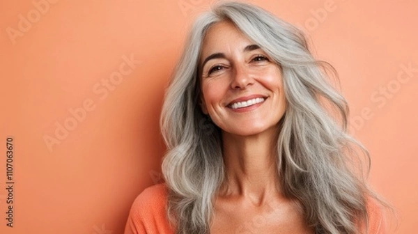 Fototapeta Image of a beautiful senior woman posing on a beauty photo session. Middle aged woman on a colored background. Concept about body positivity, self esteem and body acceptance