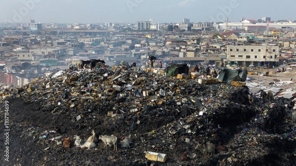 Fototapeta Ghana, Accra, 10,18,24  AGBOGBLOSHIE  people live in slum largest landfill illegal dump in Africa for electronic and plastic waste.  Odaw River High environmental toxic pollution area, climate change