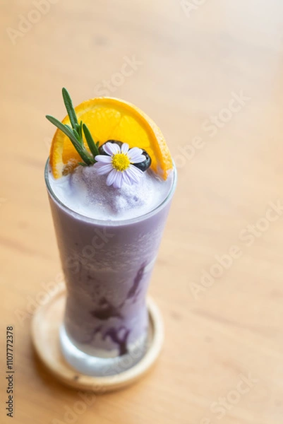 Obraz Glass of blueberry smoothie with orange and rosemary