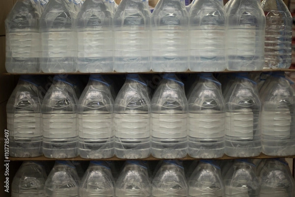 Obraz Water bottles. Water in store. Bottles in plastic packaging.