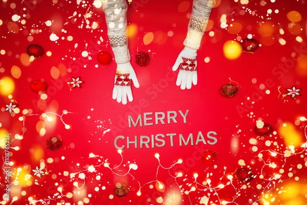 Obraz The girl is using the hand to hold the ball red decorations On a red background with christmas ornaments with led light. Top view. Christmas family traditions. Concept christmas.