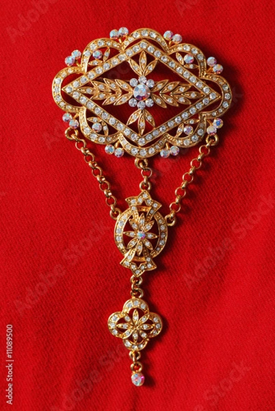 Obraz Exquisite gold brooch adorned with gems