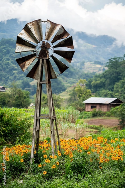 Obraz conceptual image windmill fan generate electricity in a small village generated by AI