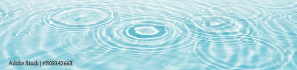 Obraz blue water surface with drop circles and sunlight reflections, empty fresh water texture banner background with copy space for beauty spa, travel or cosmetics