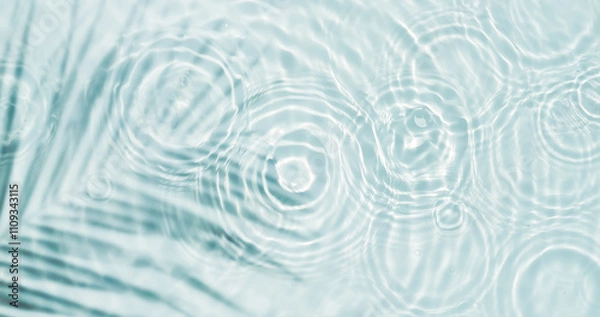 Obraz palm leaf shadow and drop circles with sunlight reflections on transparent water surface from above, water texture background concept with copy space for wellness, body and beauty care or travel