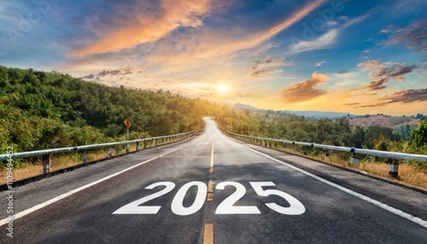 Fototapeta 2025 written on highway road in the middle of empty asphalt road at golden sunset and beautiful blue sky. Concept for new year 2025.