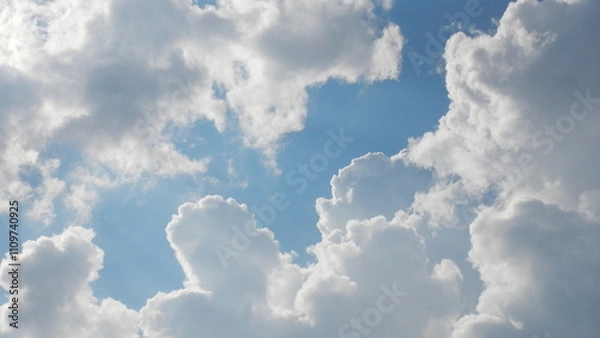 Obraz Blue and white sky background with clouds on sunny and cloudy weather. Topics: air space, meteorology, atmosphere