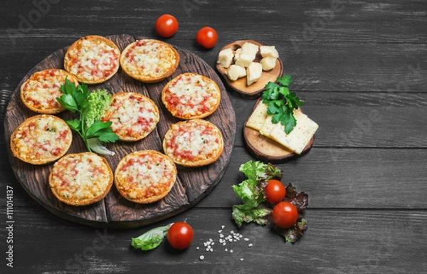 Fototapeta Small pizza with mozzarella cheese