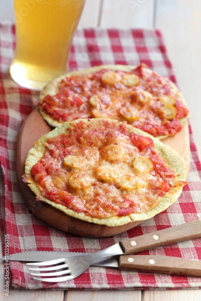Obraz Sausage and tomatoes tortilla pizzas with beer