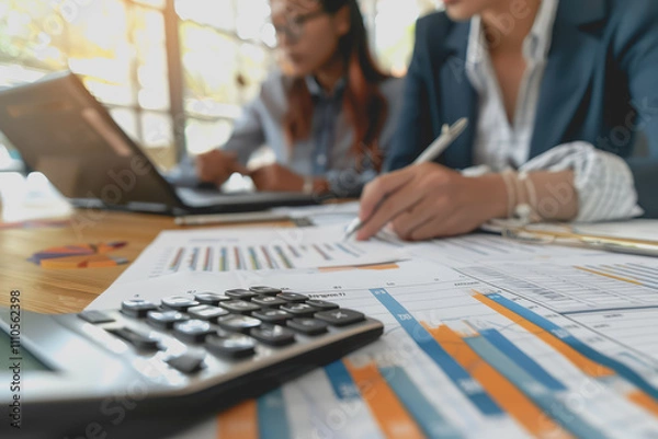 Fototapeta Business team meeting using chart calculator and analyzing business strategy financial statistics.