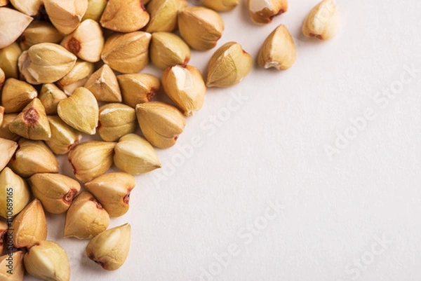 Fototapeta Layer of green buckwheat groats as food background  close-up with copy space